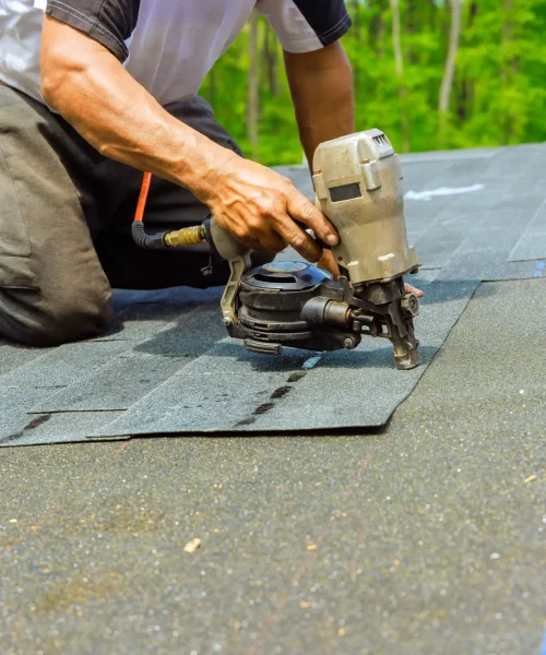 worker-installing-roofing-shingles-with-nail-gun-2026-03-24-23-53-47-utc